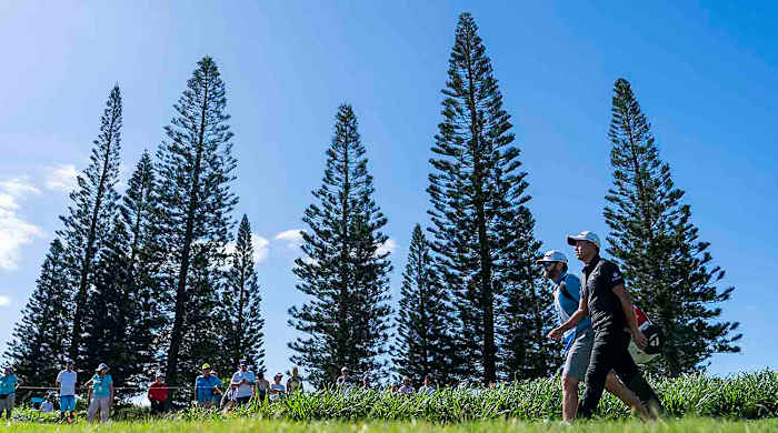 Collin Morikawa and his caddie walk on the third hole during the final round of the 2023 Sentry Tournament of Champions at Kapalua Resort in Hawai‘i.